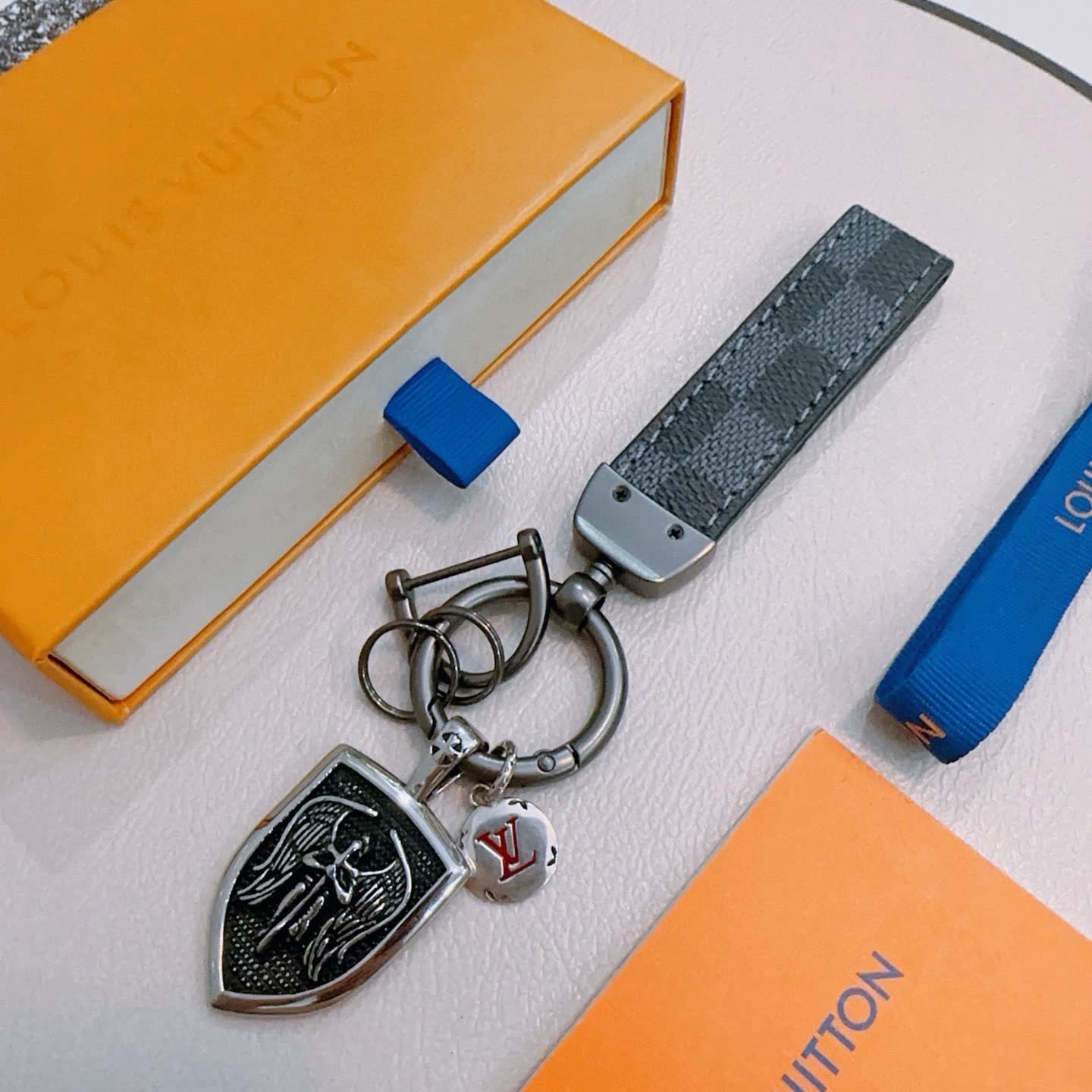 Louis Vuitton Keychain with Shield and Leather Strap Louis Vuitton Keychain with Shield and Leather Strap